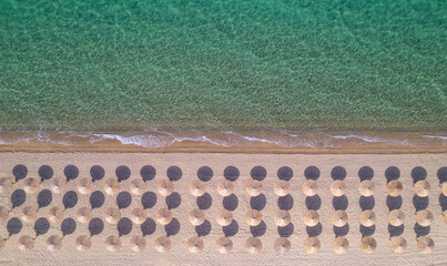 beach view from drone without people with sun umbrellas