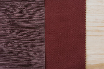 Fototapeta premium textured paper, brown red fabric, and wood