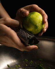 Scratching lemon to a mixture of ingredients in a bowl