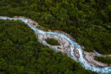 aerial view of a mountain river flowing through the forest