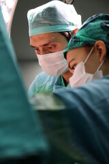 plastic surgeon performing surgery in the operating room