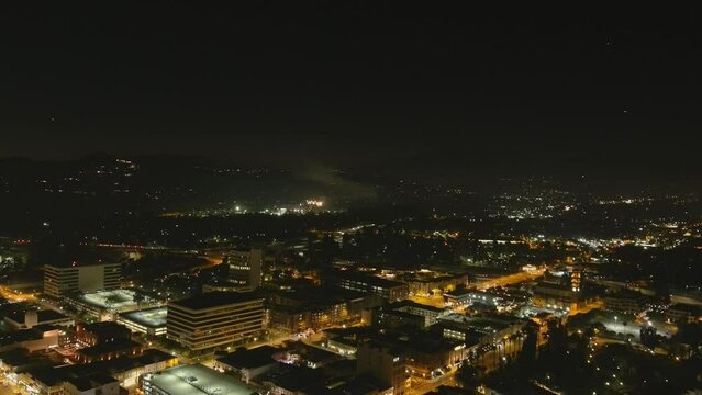 stunning aerial footage of fireworks on the fourth of July at night with a landscape filled with city lights and mountain ranges in Pasadena California USA