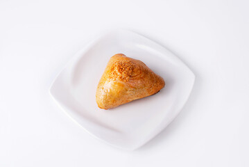 samsa in a white plate on a white background