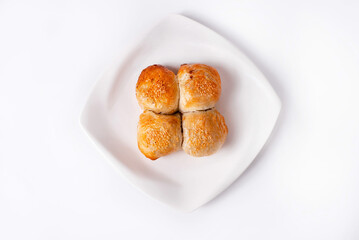 samosa made of dough with filling in a white plate on a white background