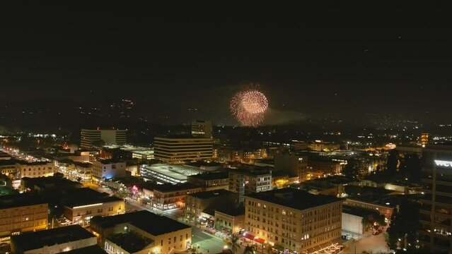 stunning aerial footage of fireworks on the fourth of July at night with a landscape filled with city lights and mountain ranges in Pasadena California USA