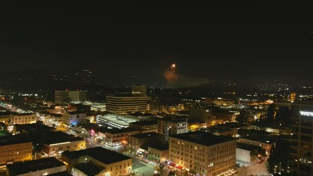 stunning aerial footage of fireworks on the fourth of July at night with a landscape filled with city lights and mountain ranges in Pasadena California USA