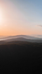Hills in fog perspective view with light horizon