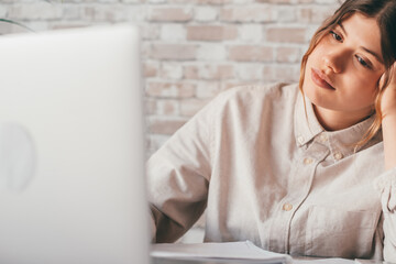 Smiling woman write notes watch webinar study work on laptop, young student  learning computer...