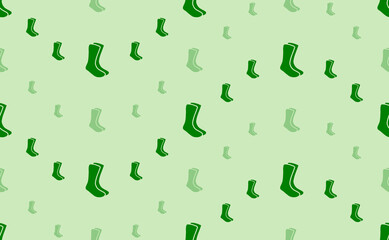Fototapeta na wymiar Seamless pattern of large and small green socks symbols. The elements are arranged in a wavy. Vector illustration on light green background