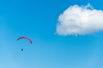 A paraglider on the background of a beautiful blue sky. Top view of the embers in the Beskid Mały. A popular place in Silesia. Bielsko Biała, Poland