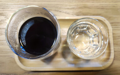Coffee and water background, black coffee and a glass of water