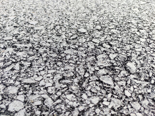 Asphalt background, sand and stones texture close view
