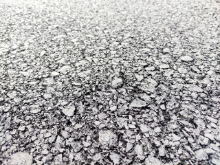 Asphalt background, sand and stones texture close view