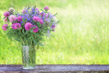 Bouquet of wild flowers on a wooden plank