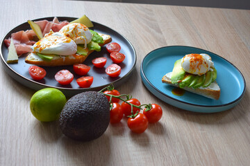 Poached Benedict Egg on a slice of baguette with avocado and cherry tomatoes.