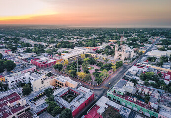 Aerial view of Valladolid Mexico City of Yucatan drone reveal the center of the town during sunset golden hour - obrazy, fototapety, plakaty