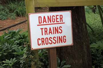 danger trains crossing sign in a rural area.