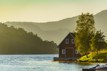 Wooden cabin on fjord shore, Norway