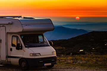 Rv camper camping in mountain at sunset.