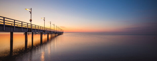 sunrise over the pier in Mechelinki. Panorama