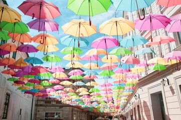 Fototapeta na wymiar Abstract design of colorful umbrellas in the sky.