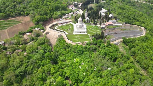 A camera drone flies forward over the Monastery of St. Nino at Bodbe, Georgia