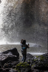 Obraz premium People are in the forest watching waterfalls and watching the beautiful nature playing in the water and relaxing on vacation. At Khao Yai National Park, Thailand, 16-05-2022