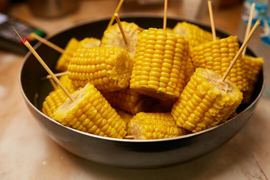 Grilled corn on a stick. head of corn on a stick. Grilled sweet corn on the cob.