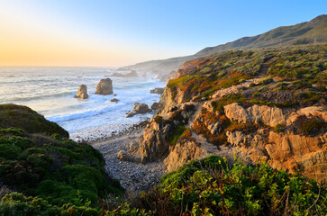 Sunset along the rocky shoreline near Big Sur along the California coast, USA.