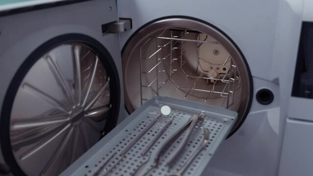 Sterilizing medical instruments in autoclave. Dental office