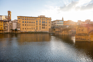 Sunset view on the riverside with old renaissance buildings in Florence, Italy. Concept of traveling Italy, visiting italian landmarks