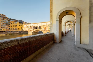 Papier Peint photo Ponte Vecchio Morning view on famous Old bridge called Ponte Vecchio and arcade on Arno river in Florence, Italy. Concept of traveling Italy and visiting italian landmarks