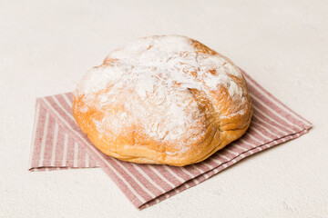Assortment of freshly baked bread with napkin on rustic table top view. Healthy unleavened bread. French bread