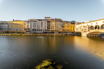 Naklejka premium Morning view on famous Old bridge called Ponte Vecchio on Arno river in Florence, Italy. Concept of traveling Italy and visiting italian landmarks