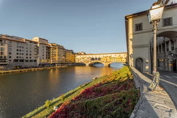 Cercles muraux Ponte Vecchio Morning view on famous Old bridge called Ponte Vecchio and arcade on Arno river in Florence, Italy. Concept of traveling Italy and visiting italian landmarks