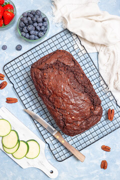 Loaf of homemade chocolate zucchini or courgette bread with pecan nuts, vertical, top view