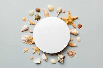 Summer time concept with blank greeting card and blank white paper on colored background. Seashells...
