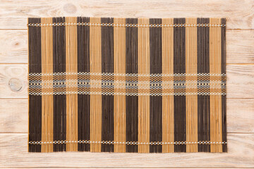 Top view of brown tablecloth for food on wooden background. Empty space for your design