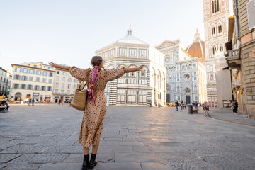 Woman enjoys beautiful view on famous Duomo cathedral in Florence, standing on empty cathedral...
