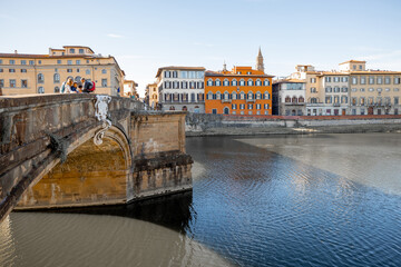 Fototapeta premium Morning view on Holy Trinity Bridge and riverside of Arno river in Florence city. Travel italian cities of Tuscany. Italian Renaissance architecture