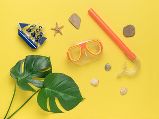 Accessories for scuba diving on a yellow background. Minimal concept of scuba diving and summer...