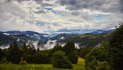 Obraz premium View from the Synevyr pass to the foggy mountains in National Natural Park Synevir, Mizhhirya district of the Transcarpathian region, Ukraine