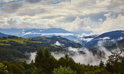 View from the Synevyr pass to the foggy mountains in National Natural Park Synevir, Mizhhirya district of the Transcarpathian region, Ukraine