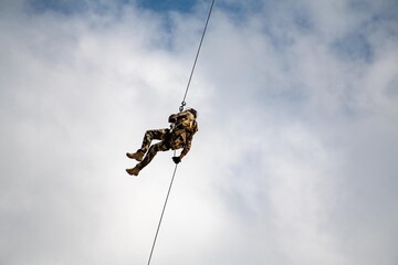 The military landing descends on a rope