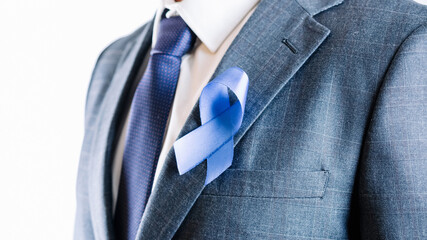 Prostate care cancer. Awareness prostate of men health in November. Business man with blue ribbon...