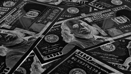 American paper money. 100 dollar and other US notes. Black and white wallpaper or background. Savings economy and the USA dollar. Dark inverted photos. Fed and federal funds rate