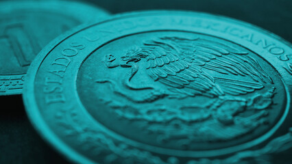 Coin 5 Mexican pesos close up. Peso of Mexico. Reverse of coin with coat of arms of country. Eagle and snake. Turquoise tinted money wallpaper. News about economy or business. Loan and credit. Macro