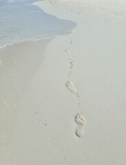 footprints on a white sand tropical beach