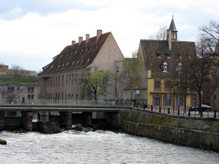Fototapeta na wymiar Bridge over the river Ile. Strasbourg. Old houses. April 2009 France. Bubbling water. Spring