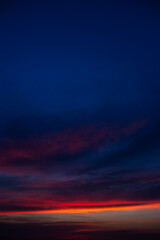 Fototapeta na wymiar Beautiful landscape of colourful sunset with dark blue clouds.